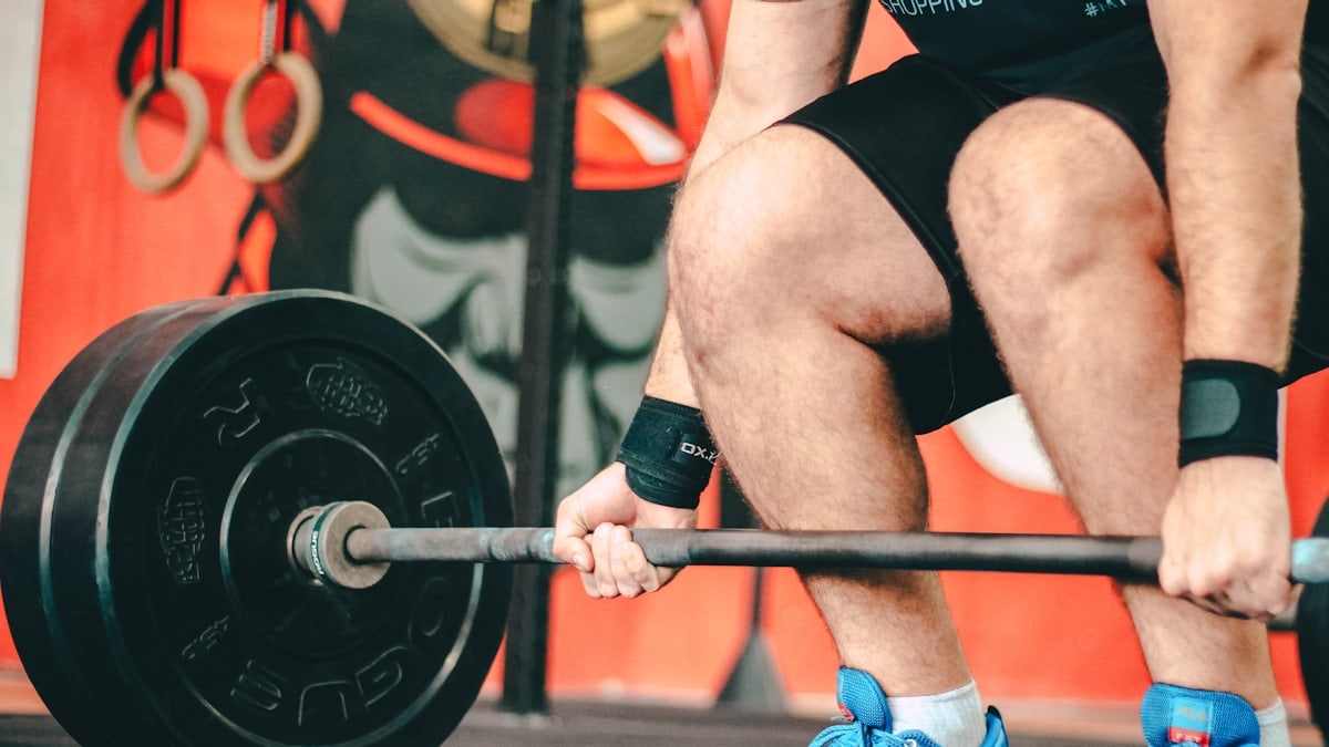 person holding barbell